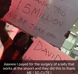 Airport workers carry placards to express gratitude to Davido for paying the bills for their colleague's surgery