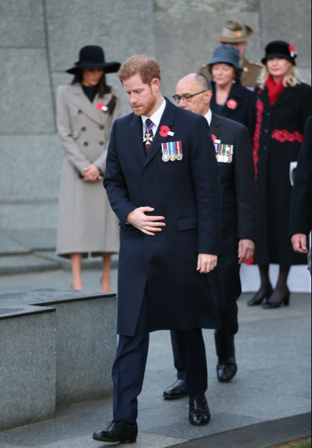 Meghan Markle and Prince Harry look sombre as they sing hymns at dawn service commemorating Anzac Day in London