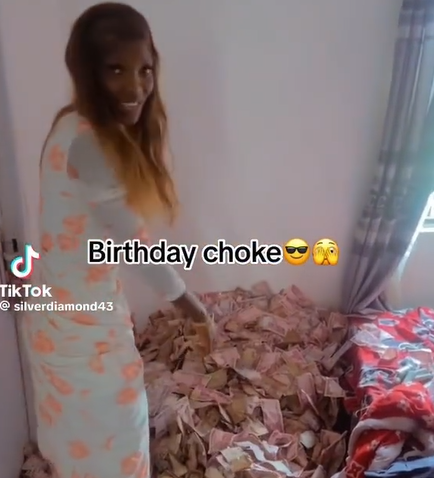 Lady shows off money she was sprayed on her birthday